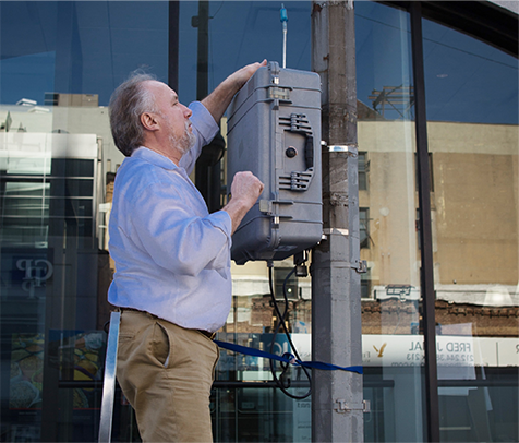 NYCCAS team member deploys a monitor in the field