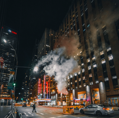 A building releases pollution over a city street